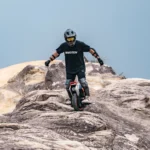 INMOTION V14 Pro rider crossing rocky terrain