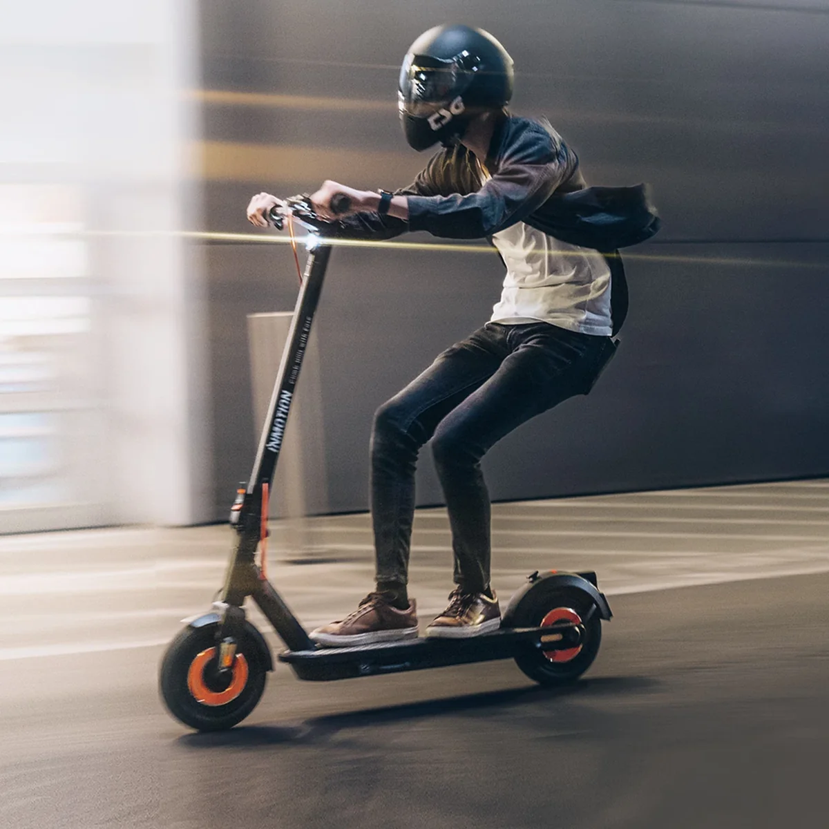 Rider wearing a helmet on an INMOTION CLIMBER electric scooter